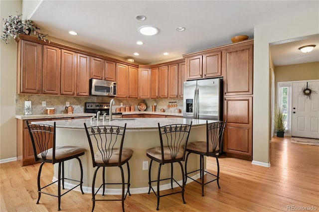 23285 Chapel Hill Ln, Parker, CO 80138 - kitchen with stainless steel appliances, tasteful backsplash, light wood finished floors, and recessed lighting