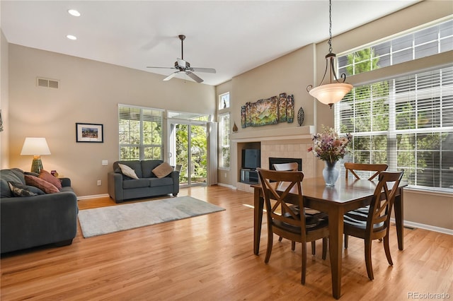 23285 Chapel Hill Ln, Parker, CO 80138 - dining space featuring a fireplace, light wood-style floors, ceiling fan, and recessed lighting