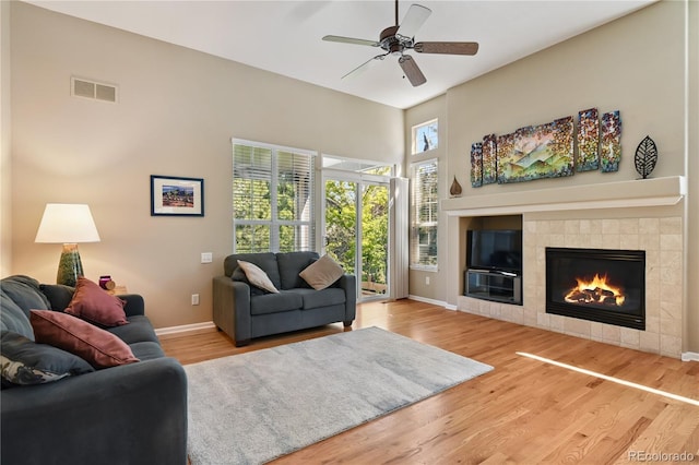 23285 Chapel Hill Ln, Parker, CO 80138 - living room with a ceiling fan, wood finished floors, and a tiled fireplace