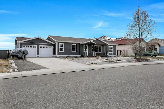 ranch-style house featuring concrete driveway and an attached garage