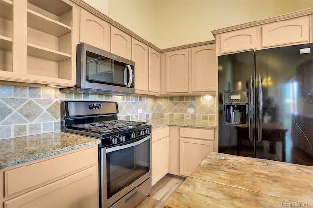 kitchen with decorative backsplash, open shelves, light stone countertops, stainless steel appliances, and light wood-style flooring