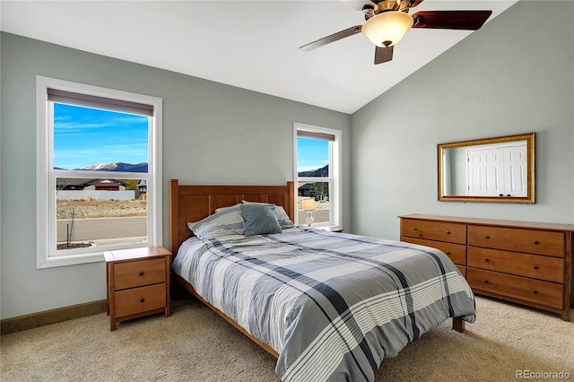 bedroom featuring baseboards, a ceiling fan, vaulted ceiling, and light carpet