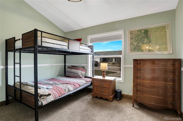 bedroom featuring baseboards, light carpet, and vaulted ceiling