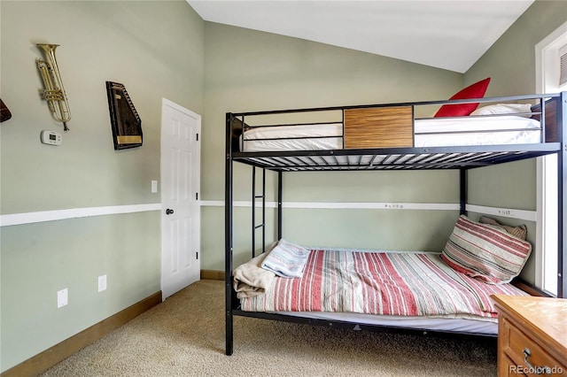 bedroom featuring carpet floors, baseboards, and lofted ceiling