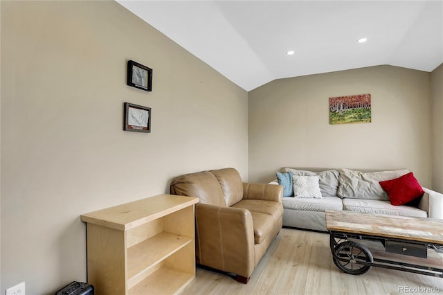living room featuring recessed lighting, vaulted ceiling, and light wood-type flooring