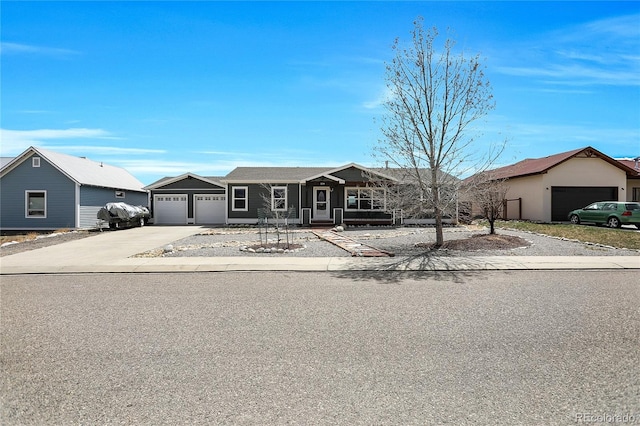 ranch-style home featuring a garage and driveway