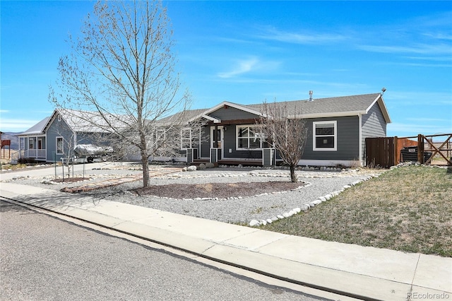 single story home with fence and covered porch