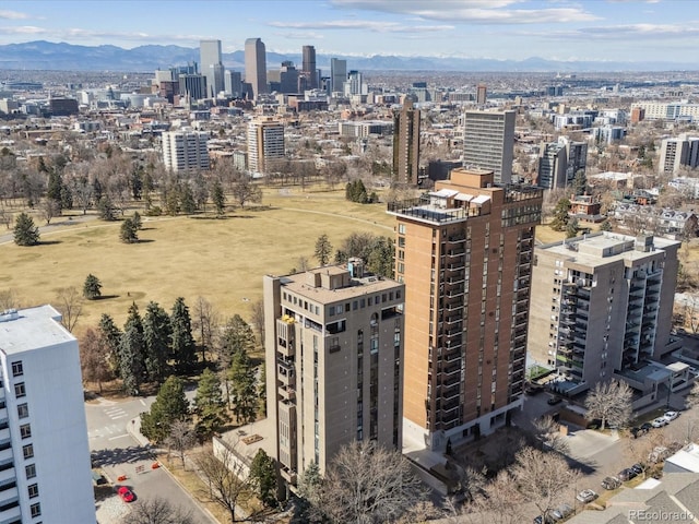 drone / aerial view featuring a mountain view and a view of city