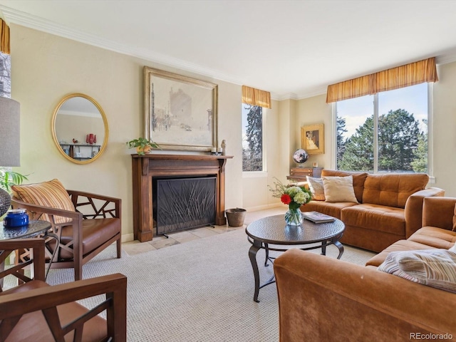 living room featuring crown molding, a fireplace with flush hearth, baseboards, and light carpet