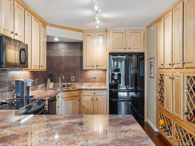 kitchen with decorative backsplash, light brown cabinets, black appliances, and a sink