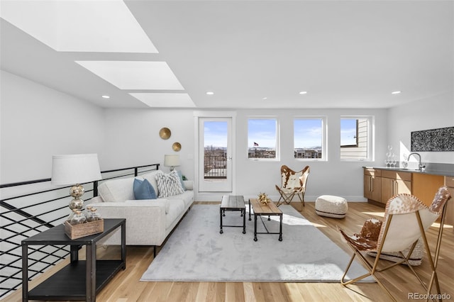 living room with sink and light hardwood / wood-style flooring