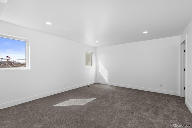 carpeted spare room featuring a wealth of natural light