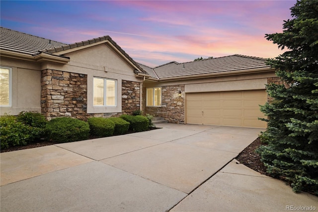14032 E Chenango Dr, Aurora, CO 80015 - ranch-style home featuring stucco siding, concrete driveway, an attached garage, and stone siding