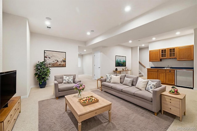 14032 E Chenango Dr, Aurora, CO 80015 - living area featuring recessed lighting, light colored carpet, stairs, and baseboards