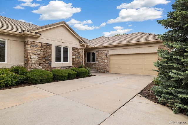 14032 E Chenango Dr, Aurora, CO 80015 - single story home featuring stone siding, stucco siding, a garage, and driveway