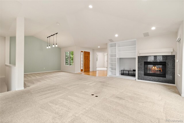 14032 E Chenango Dr, Aurora, CO 80015 - unfurnished living room with light carpet, vaulted ceiling, a fireplace, recessed lighting, and baseboards