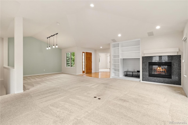 14032 E Chenango Dr, Aurora, CO 80015 - unfurnished living room with light carpet, vaulted ceiling, a high end fireplace, recessed lighting, and baseboards