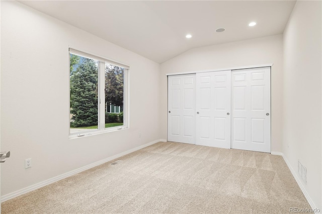 14032 E Chenango Dr, Aurora, CO 80015 - unfurnished bedroom with light colored carpet, recessed lighting, baseboards, lofted ceiling, and a closet