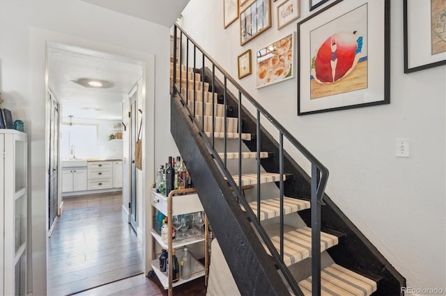 staircase with wood finished floors