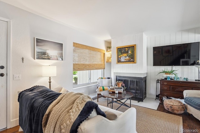 living area featuring a fireplace and baseboards