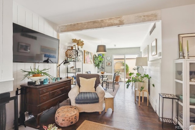 living area featuring beam ceiling, visible vents, and dark wood-style floors