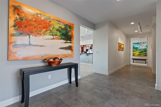 corridor featuring dark tile patterned flooring