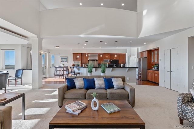 living room featuring light carpet and high vaulted ceiling