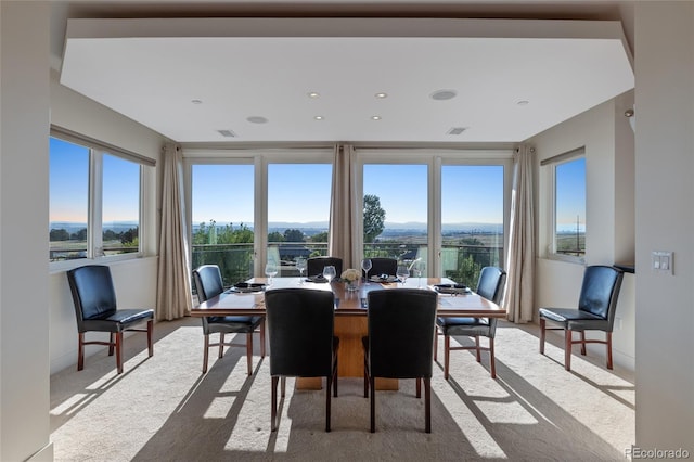 dining room with light colored carpet