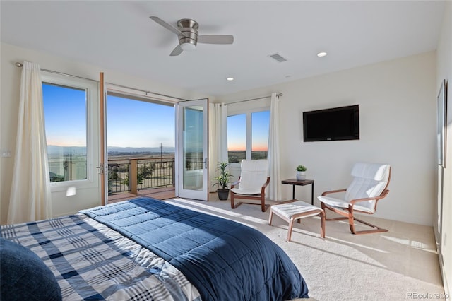 bedroom featuring access to exterior, ceiling fan, and light colored carpet