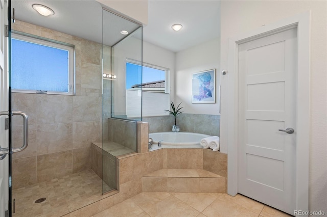 bathroom with tile patterned flooring and shower with separate bathtub