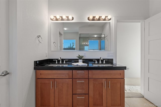 bathroom featuring a shower, vanity, and tile patterned floors