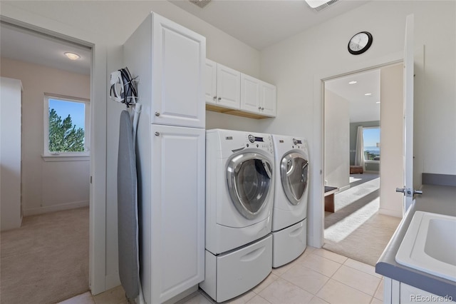 laundry room featuring cabinets, washer and dryer, light colored carpet, and sink