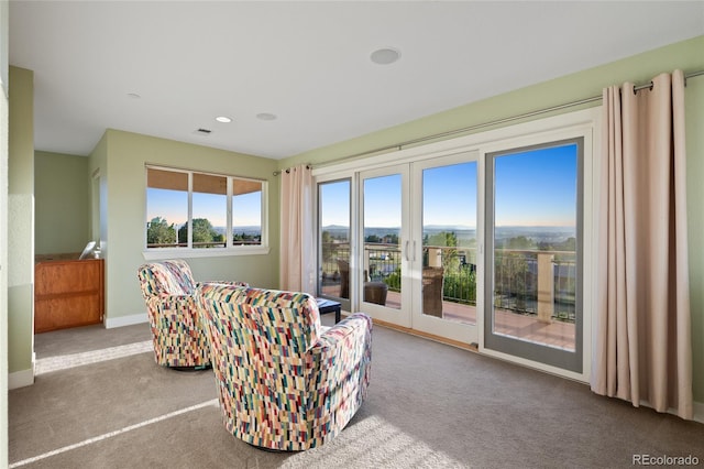 sitting room with carpet floors and french doors