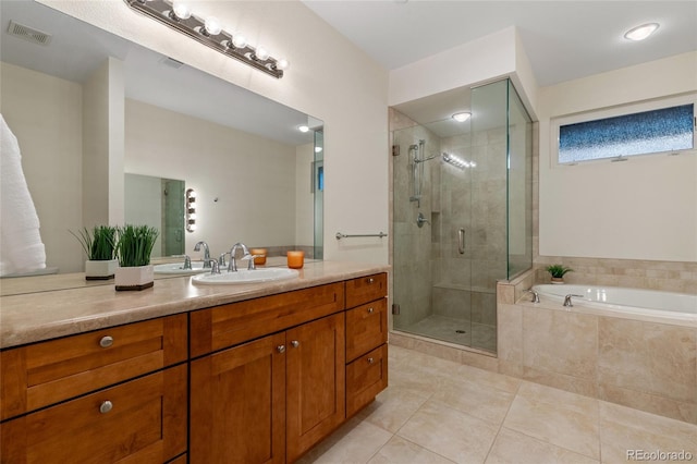 bathroom with vanity, tile patterned flooring, and plus walk in shower