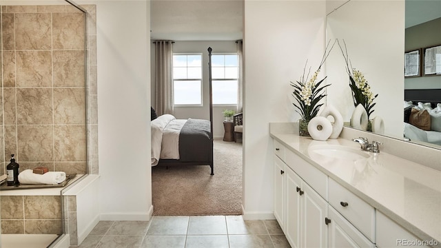 bathroom featuring tile patterned flooring, vanity, and walk in shower