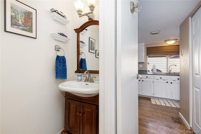 bathroom with vanity and hardwood / wood-style flooring