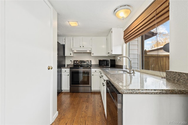 kitchen featuring sink, dark stone countertops, white cabinets, black appliances, and dark wood-type flooring