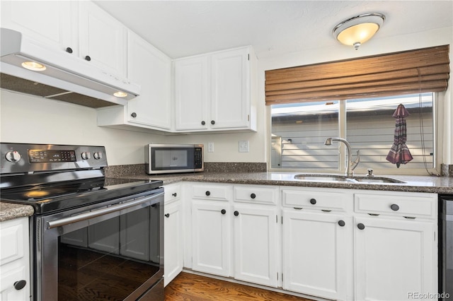 kitchen featuring stainless steel appliances, dark hardwood / wood-style floors, sink, and white cabinets