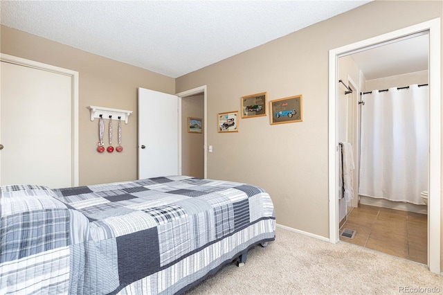 carpeted bedroom featuring a textured ceiling