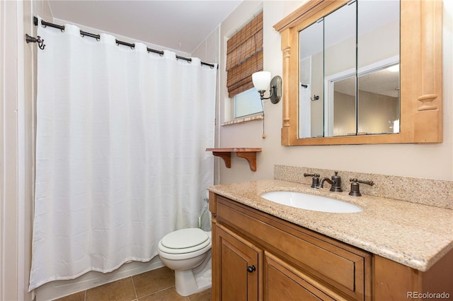 bathroom featuring tile patterned flooring, vanity, and toilet