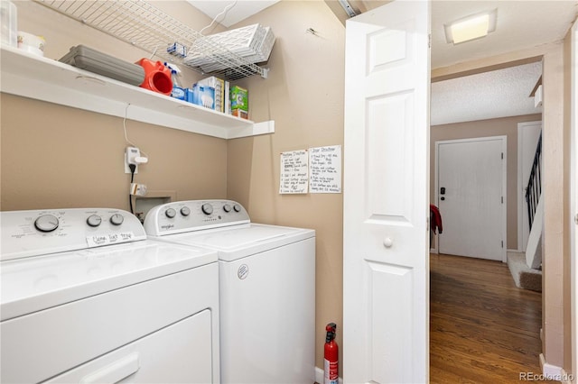 clothes washing area featuring hardwood / wood-style floors and independent washer and dryer