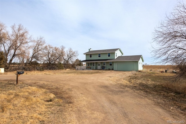 exterior space with covered porch and dirt driveway