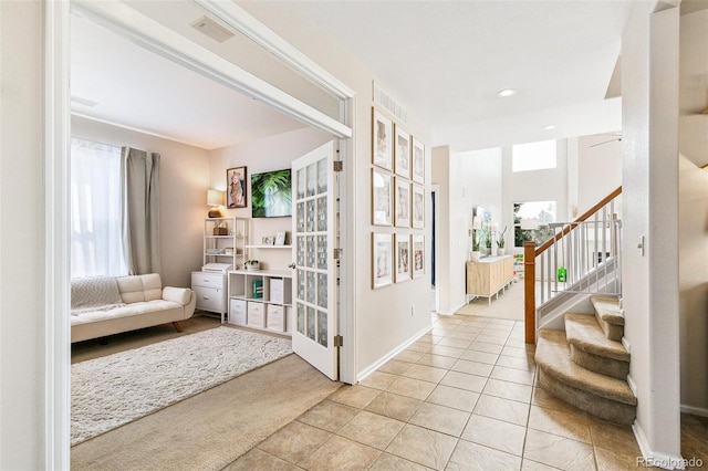 interior space featuring light tile patterned floors, stairs, visible vents, baseboards, and recessed lighting