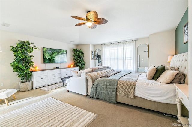 bedroom with a ceiling fan and light colored carpet