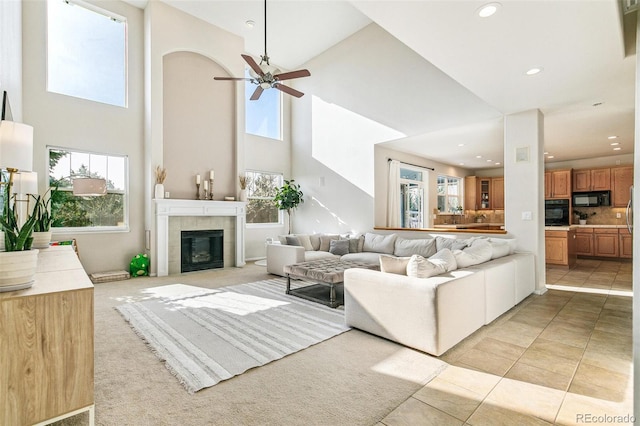 3532 Springbriar Dr, Castle Rock, CO 80109 - living room featuring a towering ceiling, ceiling fan, recessed lighting, a fireplace, and light tile patterned flooring