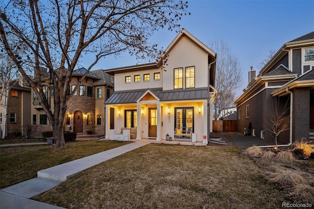 back of property featuring a standing seam roof, french doors, board and batten siding, and metal roof