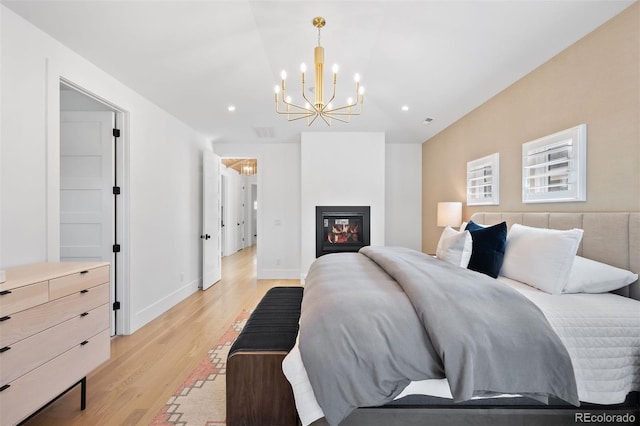 bedroom with a chandelier, light wood-type flooring, recessed lighting, and baseboards