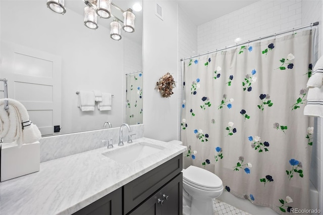 bathroom featuring toilet, shower / tub combo, and vanity