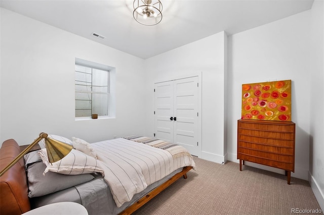 bedroom with carpet, baseboards, and a closet