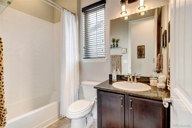 full bathroom with vanity, shower / bath combo, and toilet